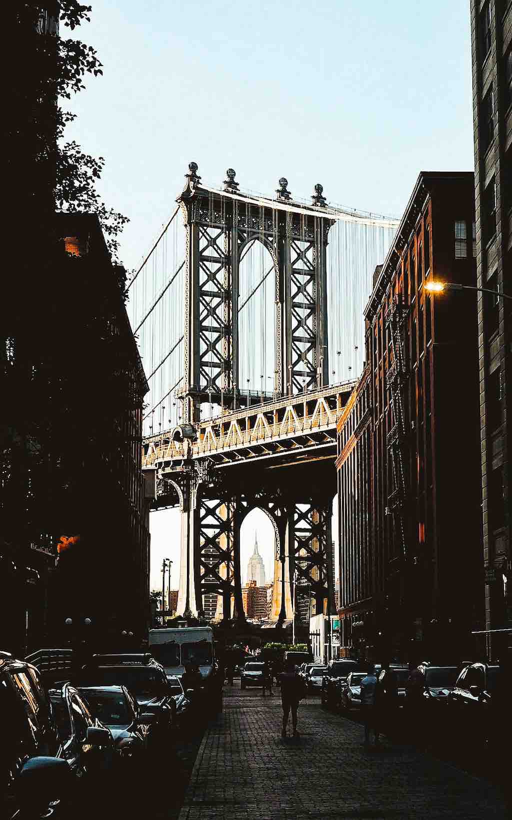A view of DUMBO (Down Under the Manhattan Bridge Overpass). You can see the Manhattan Bridge framing the Empire State Building in New York City
